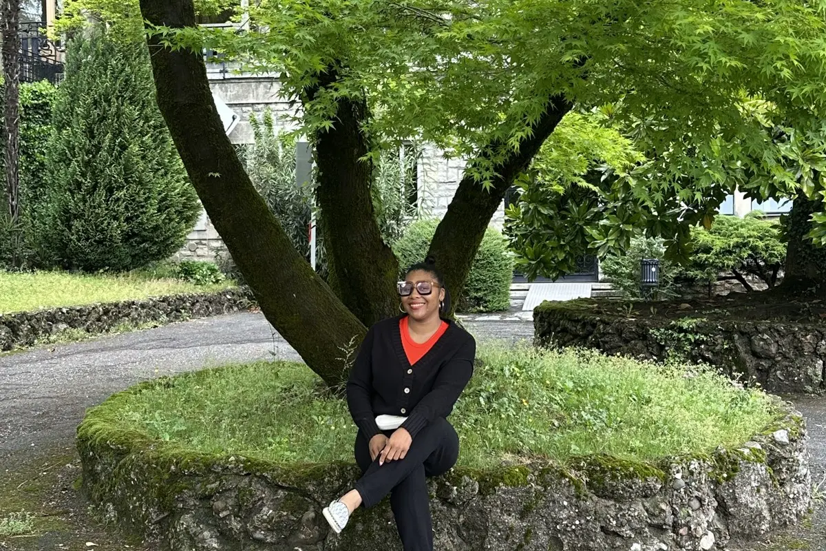Dr. Ates seated beneath a tree